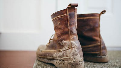 a pair of work boots with mud on them