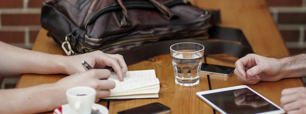 two people meeting with business equipment and coffee