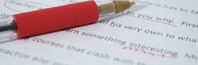 proofreading pen on paper with markups