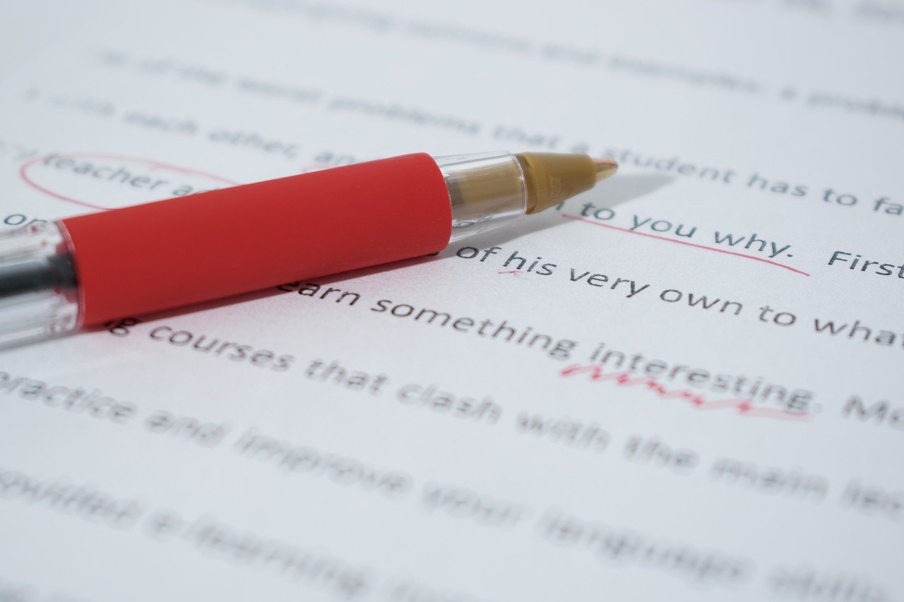 proofreading pen on paper with markups