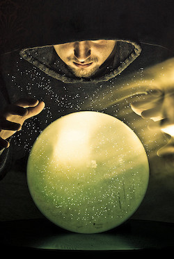 man looking into crystal ball